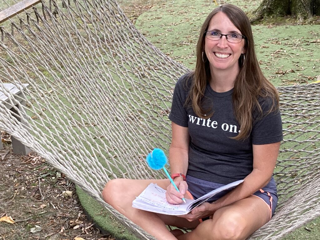 smiling teaching sitting in a hammock inviting you to learn about teaching writing